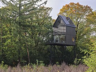 Das Baumhaus mit Sonnenkollektoren ist angelehnt an klassische Vogelhäuschen. Es schwebt acht Meter über dem Waldboden. 
